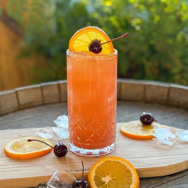 A fruity beverage in a tall glass